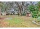 Large backyard with mature trees and two small storage sheds at 912 Enterprise Ave, New Smyrna Beach, FL 32168