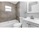 Bathroom featuring tiled shower, white vanity, toilet and towel rack at 912 Enterprise Ave, New Smyrna Beach, FL 32168