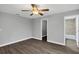 Bedroom features gray walls and flooring and a ceiling fan at 912 Enterprise Ave, New Smyrna Beach, FL 32168