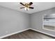 Cozy bedroom featuring neutral walls, ceiling fan, and complemented by luxury vinyl plank flooring at 912 Enterprise Ave, New Smyrna Beach, FL 32168