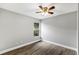 This bedroom features wood-look flooring, a ceiling fan and a window with outside view at 912 Enterprise Ave, New Smyrna Beach, FL 32168