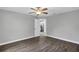 Bedroom featuring gray walls, flooring, ceiling fan, and white trim at 912 Enterprise Ave, New Smyrna Beach, FL 32168