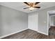 Bedroom with closet, gray walls and flooring, and a ceiling fan at 912 Enterprise Ave, New Smyrna Beach, FL 32168