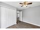 Bedroom features updated gray walls and flooring and a ceiling fan at 912 Enterprise Ave, New Smyrna Beach, FL 32168