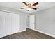 Bedroom features updated gray walls and flooring and a ceiling fan at 912 Enterprise Ave, New Smyrna Beach, FL 32168