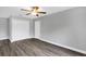 Bright bedroom featuring wood-look flooring, ceiling fan and a closet at 912 Enterprise Ave, New Smyrna Beach, FL 32168