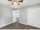 This bedroom features wood-look flooring, a ceiling fan and a closet at 912 Enterprise Ave, New Smyrna Beach, FL 32168