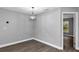 Corner of dining area featuring stylish light fixture and vinyl flooring, naturally lit at 912 Enterprise Ave, New Smyrna Beach, FL 32168