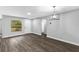 Open living space with vinyl floors, featuring a modern light fixture and a secure entrance at 912 Enterprise Ave, New Smyrna Beach, FL 32168