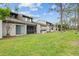 Backyard view of home featuring a screened-in patio at 95 Carolwood Blvd, Fern Park, FL 32730