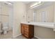 Well-lit bathroom with a single vanity, tile flooring, and a shower with white subway tile at 95 Carolwood Blvd, Fern Park, FL 32730