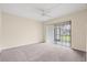 Cozy bedroom with neutral walls and carpet, and a sliding glass door leading to the outdoors at 95 Carolwood Blvd, Fern Park, FL 32730