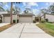 Inviting townhome showcasing an attached garage, clean driveway, and manicured front yard at 95 Carolwood Blvd, Fern Park, FL 32730