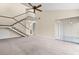 Spacious living room featuring a staircase, neutral walls, a ceiling fan, and sliding glass doors at 95 Carolwood Blvd, Fern Park, FL 32730