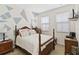 Charming bedroom featuring geometric accent wall, and natural light from the two windows at 3446 Allegra Cir, St Cloud, FL 34772