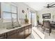 Kitchen featuring granite counters, tile floors, and a dining area with sliding glass doors at 3446 Allegra Cir, St Cloud, FL 34772