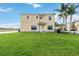 Two-story home with a well-manicured lawn and two palm trees on the right side of the home at 3446 Allegra Cir, St Cloud, FL 34772