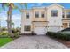 Two-story townhouse featuring a two-car garage, landscaped yard, and a beautiful brick driveway at 3446 Allegra Cir, St Cloud, FL 34772