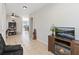 Open-concept living room with tile floors, neutral paint, and water views from the adjacent dining area at 3446 Allegra Cir, St Cloud, FL 34772