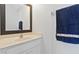 Powder room featuring a vanity with a solid surface top, decorative mirror, and towel rack at 3446 Allegra Cir, St Cloud, FL 34772