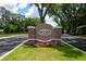 Fire Creek at Gotha community sign with stone accents, lush greenery, and colorful flowers at 10055 Brocksport Cir, Gotha, FL 34734