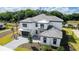 Aerial view of a luxurious two-story house with a gray tiled roof and a paved driveway at 10055 Brocksport Cir, Gotha, FL 34734