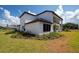 Modern white house with brown trim, well-maintained landscaping and beautiful blue skies at 10055 Brocksport Cir, Gotha, FL 34734