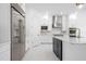 Bright, modern kitchen featuring white cabinetry, stainless steel appliances, an island, and a marble backsplash at 10055 Brocksport Cir, Gotha, FL 34734