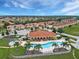 Aerial view of community with pool, clubhouse, and neatly arranged townhomes at 1183 Chervil Dr, Poinciana, FL 34759