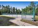 Community basketball court with chain link fence and wooded surround at 1183 Chervil Dr, Poinciana, FL 34759