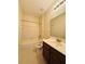 Bathroom features vanity with sink, mirror, and shower-tub with white tile at 1183 Chervil Dr, Poinciana, FL 34759