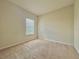 Bedroom with carpeted floor, beige walls, and a window with blinds at 1183 Chervil Dr, Poinciana, FL 34759