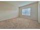 Bedroom with carpeted floor, beige walls, and a window with blinds at 1183 Chervil Dr, Poinciana, FL 34759