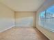 Bedroom with carpeted floor, beige walls, and a window with blinds at 1183 Chervil Dr, Poinciana, FL 34759