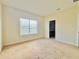 Bedroom with carpeted floor, beige walls, and a window with blinds at 1183 Chervil Dr, Poinciana, FL 34759