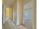 Hallway showing carpeted floors with doorways to bedrooms or other rooms at 1183 Chervil Dr, Poinciana, FL 34759