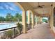 Poolside veranda with tiled floor, ceiling fans and wrought iron railing at 1183 Chervil Dr, Poinciana, FL 34759