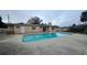 Backyard pool connected to the back of the home with concrete deck at 1201 S Oxalis Ave, Orlando, FL 32807