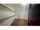 Unfinished basement featuring open shelving, ceramic tile floor, and white painted door at 1201 S Oxalis Ave, Orlando, FL 32807