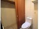 Bathroom features a toilet, and wood door closet at 1201 S Oxalis Ave, Orlando, FL 32807