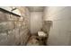 Small unfinished bathroom with a basic sink, white tile walls, and tiled floor at 1201 S Oxalis Ave, Orlando, FL 32807