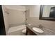 Bathroom featuring a tub and shower combination, granite vanity and a decorative mirror at 1201 S Oxalis Ave, Orlando, FL 32807