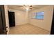 Image of bedroom features a ceiling fan, tiled floor and window with blinds at 1201 S Oxalis Ave, Orlando, FL 32807