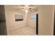 This bedroom features tile flooring, a ceiling fan, and a large window providing natural light at 1201 S Oxalis Ave, Orlando, FL 32807