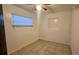 This bedroom features tile flooring and a window for natural light at 1201 S Oxalis Ave, Orlando, FL 32807