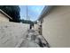 Exterior view of the side yard showing the wall, side of building and a gate to the backyard at 1201 S Oxalis Ave, Orlando, FL 32807