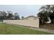 Long exterior wall with a view to landscaping in the distance at 1201 S Oxalis Ave, Orlando, FL 32807