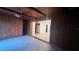 View of the living room and kitchen featuring wood paneled walls and tiled floors at 1201 S Oxalis Ave, Orlando, FL 32807