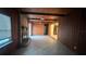 Wood-paneled living room with a brick fireplace, tile flooring, and natural light at 1201 S Oxalis Ave, Orlando, FL 32807