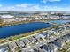 Scenic aerial view of neighborhood homes with lake showcasing the community's beautiful landscaping at 1204 Pando Loop, Orlando, FL 32824